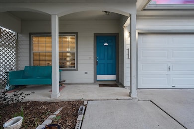 View of exterior entry with covered porch and a g