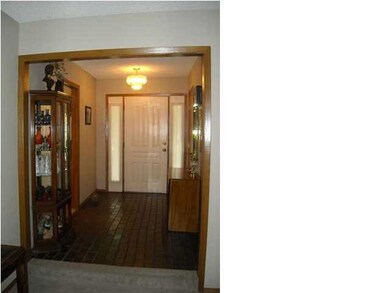 Nice-sized foyer for welcoming guests with tile fl