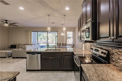 Kitchen featuring ceiling fan, appliances with sta