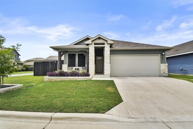 Ranch-style house with stone siding, a garage, a 
