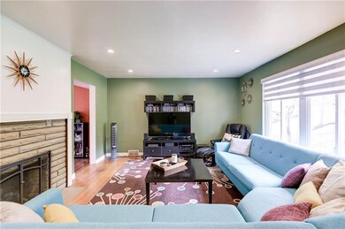 A large window with custom window treatment and recessed lighting provide plenty of light to this space.