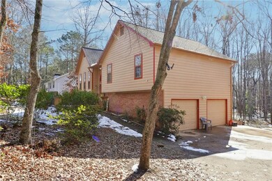 View of home's exterior with driveway, roof with s