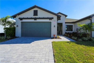 View of front of home with a garage and a front ya
