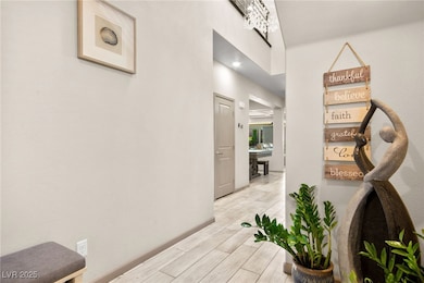 Hall featuring wood tiled floors and baseboards