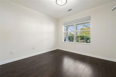 Spare room featuring baseboards, visible vents, an
