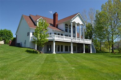 A view of the luscious lawn and back of the home i