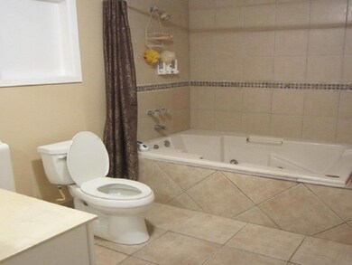 Master Bathroom with spa tub and custom ceramic ti