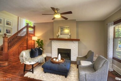 Natural woodwork and staircase compliments fireplace sitting space...