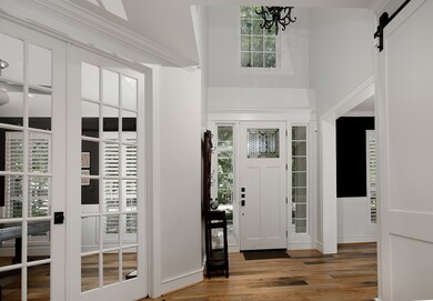 Elegant craftsman-style front door with custom window and sidelights