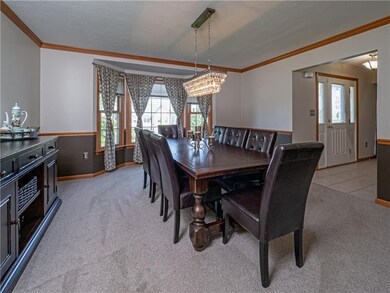An elegant dining room features a bright bay windo