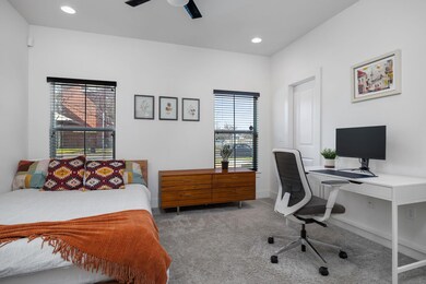 Carpeted bedroom with a desk, recessed lighting, 
