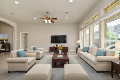 The spacious living area features abundant natural light, creating a warm and inviting atmosphere. Perfect for gatherings, the room is designed for comfort and style, with ample seating and elegant finishes.
