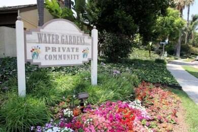 Colorful blooms and tropical vegetation surround y