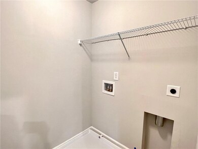 Laundry room with hookup for an electric dryer and hookup for a washing machine