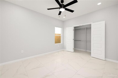 Unfurnished bedroom with ceiling fan and a closet