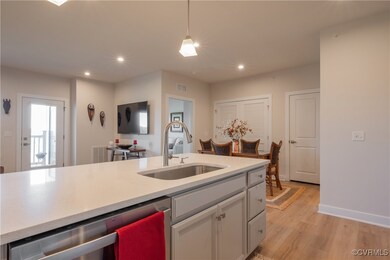 Kitchen featuring hanging light fixtures, sink, st