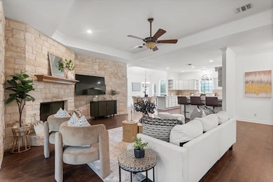 Living area with ceiling fan, ornamental molding,
