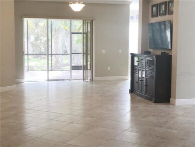 Living room flows to covered and screened lanai to