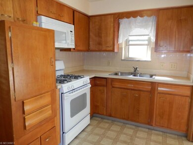 Eat-in Kitchen with wood cabinetry and all appliances.