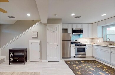Kitchen with decorative backsplash, a sink, and st