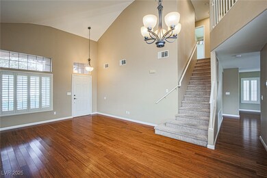 Entryway with wood-type flooring, stairway, high v