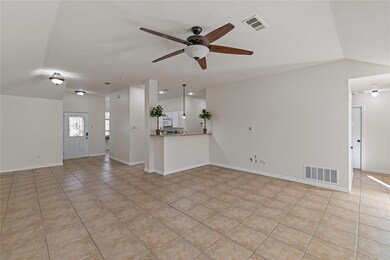 Unfurnished living room with ceiling fan, light ti