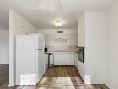 Kitchen featuring freestanding refrigerator, a sin