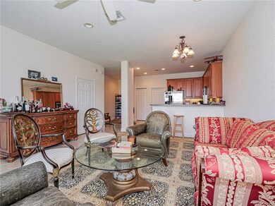 Living room with recessed lighting, a chandelier, light tile patterned flooring, and a ceiling fan