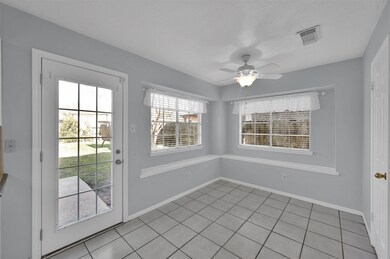 Breakfast room wrapped with windows overlooks back