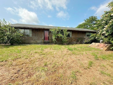 Ranch-style home featuring a front lawn