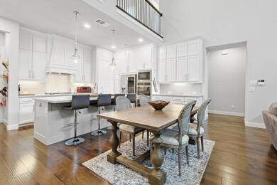 Dining space with sink, dark wood-type flooring, and a high ceiling