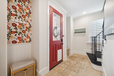 Entryway leads into downstairs hallway, bedroom/of