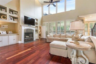 GREAT ROOM WITH CUSTOM BUILT-INS AND WALL OF WINDO