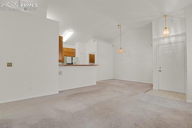 Living room and dining area with carpet, high vaulted ceiling