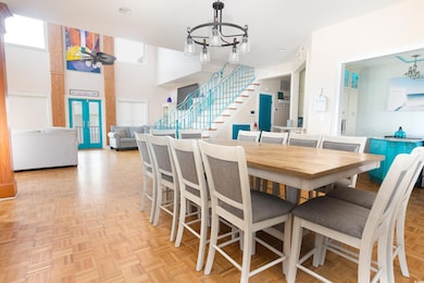 Dining room with a chandelier and stairs