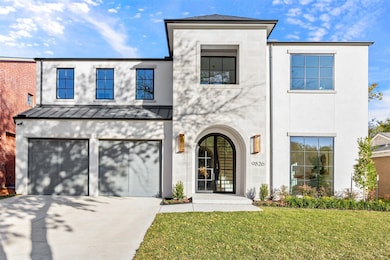View of front of home featuring driveway, stucco siding, a standing seam roof, a front lawn, and a garage