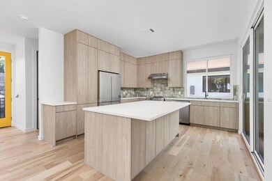 Kitchen with stainless steel appliances, light br