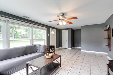 View of the living area looking into the entry way which has a coat closet.