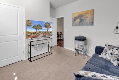 Living room with light carpet and baseboards