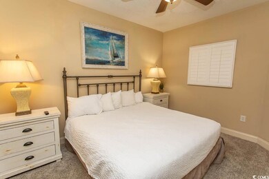 Carpeted bedroom featuring baseboards and a ceiling fan