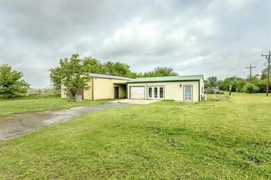 Rear view of house with a lawn, aphalt driveway, f
