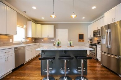 Stunning kitchen with granite, tile backsplash, stainless steel appliances, upgraded cabinets, an island, and the list goes on...