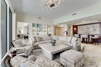 Living room featuring ornamental molding and a cha