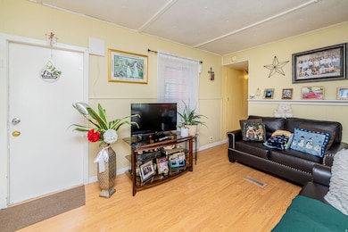 Living room featuring wood finished floors and baseboards