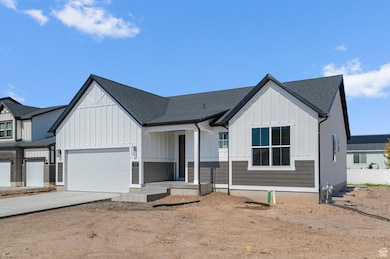 Modern farmhouse featuring board and batten siding, roof with shingles, driveway, covered porch, and an attached garage