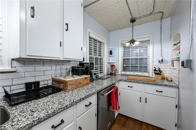 Kitchen with stainless steel dishwasher, white cab