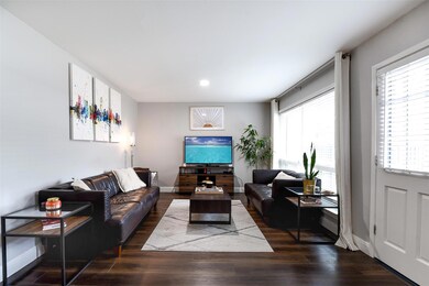 Living area featuring baseboards, dark wood-style