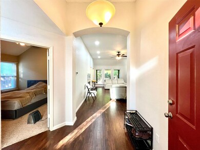 Entrance foyer featuring ceiling fan and dark wood-type flooring