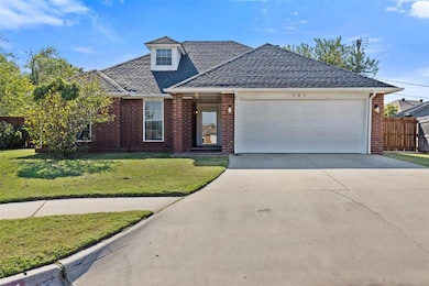 View of front facade featuring concrete driveway, a shingled roof, brick siding, and an attached garage