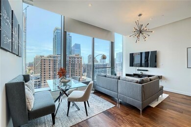 Living room featuring an inviting chandelier, bas